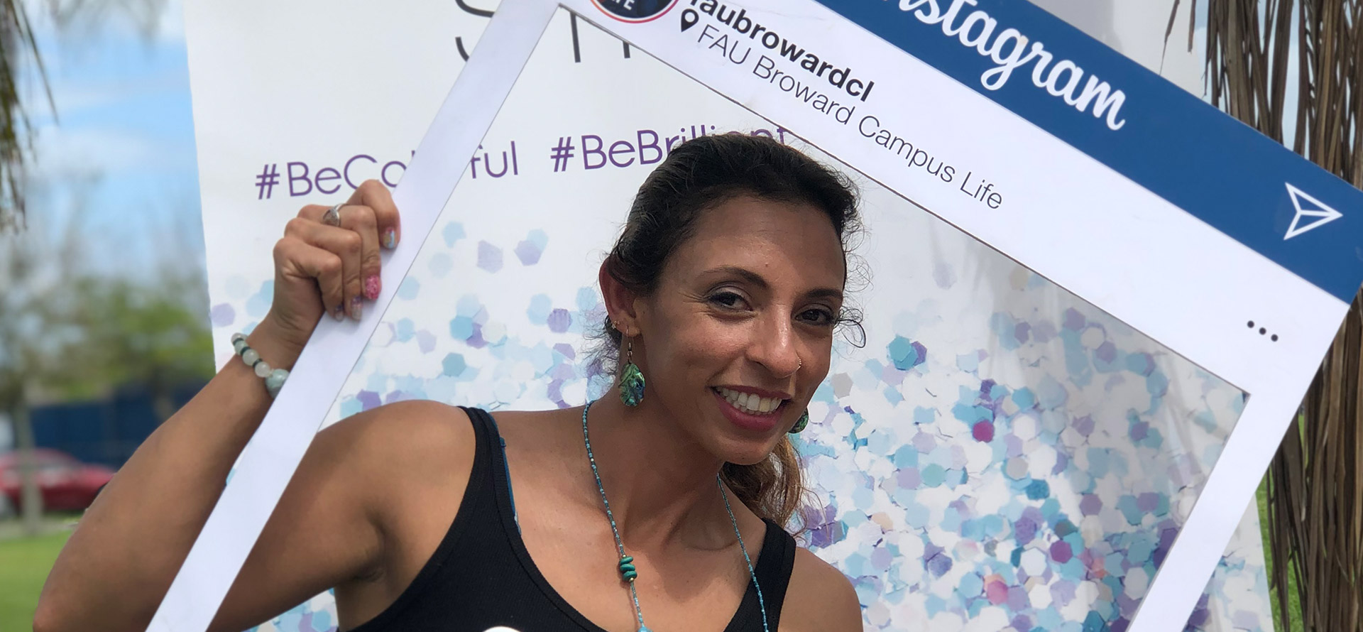 Student taking a picture with a instagram post cutout