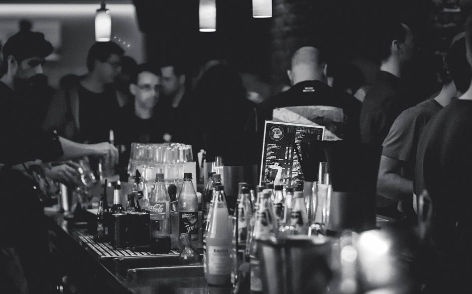 a black and white photo of various glass bottles on a countertop