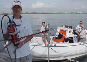 Three undergraduate students and a graduate student testing an FAU Dual Purpose Acoustic Modem off the coast of Fort Lauderdale, Florida.