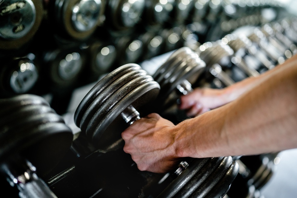 Image of a hand, picking up a dumbell