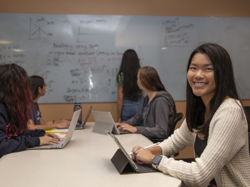 Image of students in a classroom sitting at a table