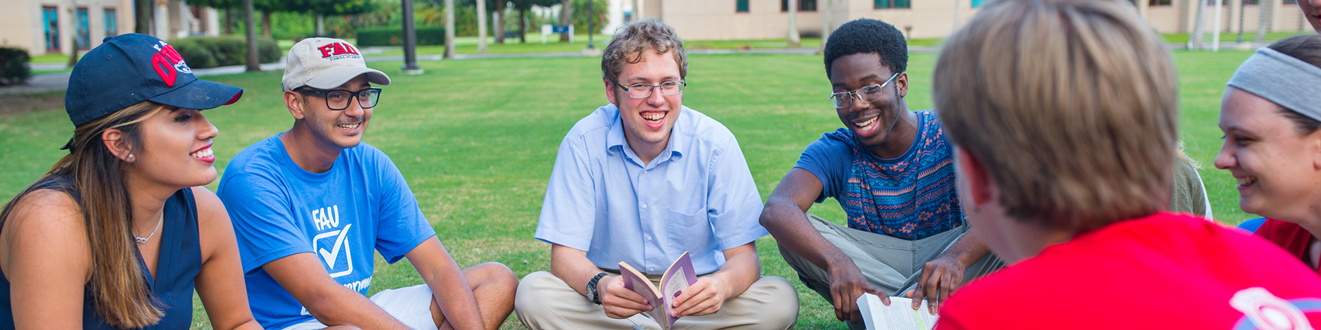 Students sitting on the lawn in a circle