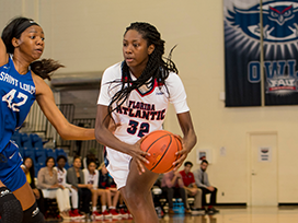 Two female basketball players playing basketball