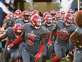 Football team coming out of the locker room in uniform before a game