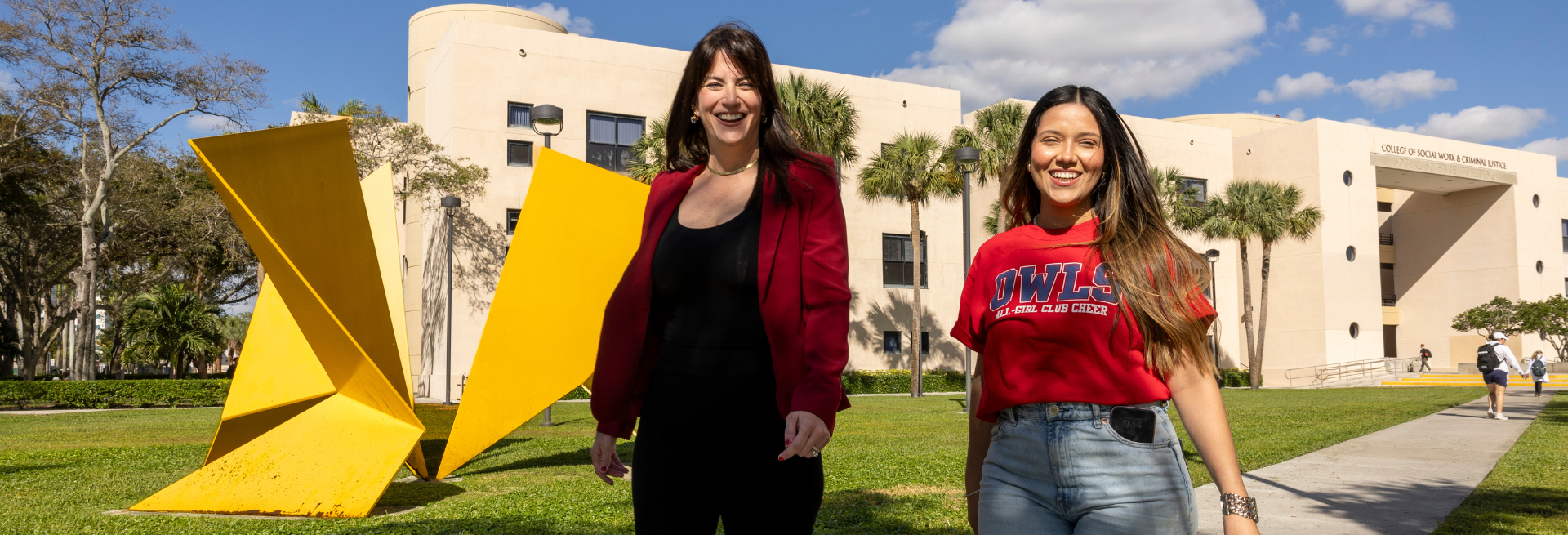 Professor and student walking in front of the Social Sciences building at FAU