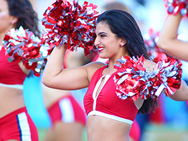 Female cheerleaders on the field during a game.